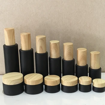 1oz 2oz 50ml CBD kanapių kremo stiklainiai 15g 30g 50g 10g matinio juodo kosmetinio kremo pakuotės stiklinis indelis su bambuko plastikiniu dangteliu